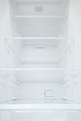 An empty refrigerator. Inside an empty, clean refrigerator, a refrigerator compartment after defrosting. shot with a wide angle lens