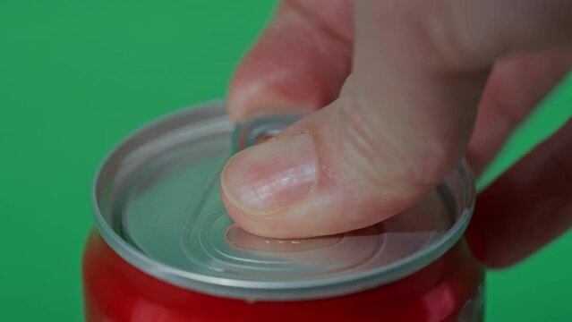 close up woman opens can drink pours down slow motion Refreshing Soda isolated green background