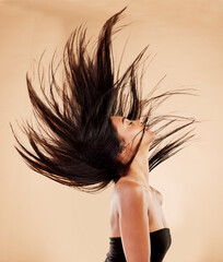 Woman, hair in air and beauty with cosmetics, keratin treatment and shine isolated on studio background. Female model profile, wind and haircare with cosmetology, Brazilian and texture with growth