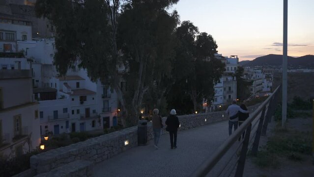 People walking in Dalt Vila district and Ibiza Cathedral at dusk, UNESCO World Heritage Site, Ibiza Town, Ibiza, Balearic Islands, Spain