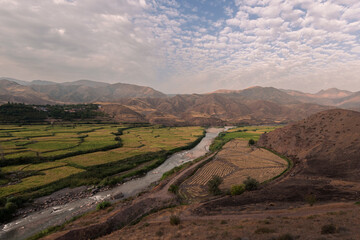 river leading to the rice field terraces, large landscape, green, sky, blue, clouds, spring