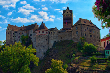 Landscape view of medieval Loket castle in Czech Republic. Famous touristic place and romantic travel destination. Romantic castle with colorful houses. UNESCO World Heritage Site