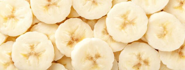 Background of ripe sliced yellow healthy banana slices, closeup. Food organic natural backdrop from...