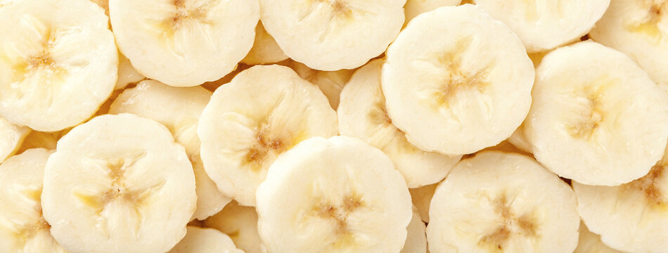 Background of ripe sliced yellow healthy banana slices, closeup. Food organic natural backdrop from fruit
