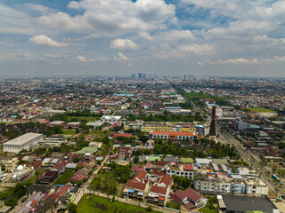 The city of Medan with dense buildings and streets view from above. Sumatra, Indonesia.