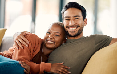 Happy hug, interracial couple and portrait on a sofa at home with love and care in a living room. Woman, young people and together in a house sitting on a lounge couch relax with support and embrace - Powered by Adobe