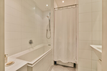 a bathroom with a shower and bathtub in the corner next to it is a white towel hanging on the wall
