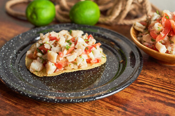 Close up of a delicious tostada of ceviche. Concept Peruvian food, mexican food.