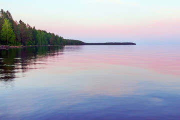 Evening summer landscape of the water surface after sunset.