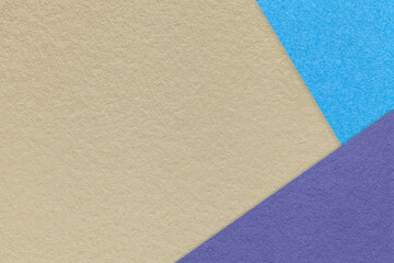 Fototapeta na wymiar Texture of craft beige color paper background with blue and violet border. Vintage abstract brown cardboard.