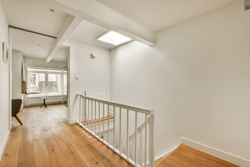 an empty room with wood floors and white walls, there is a staircase leading up to the second floor...
