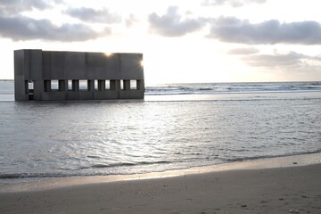Obraz premium Building shell concrete at the beach of the sea with blue sky and clouds