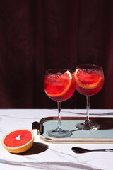 Spritz veneziano, an aperitif cocktail with Prosecco, bitter, soda, ice and  blood red oranges (tarocco). Aperitif with in style Milanese. Retro chic style, festive mood