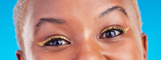 Makeup portrait, eyeliner and eyes of black woman with studio beauty, wellness and facial cosmetics for skincare shine. Mascara, cosmetology design and closeup African person on blue background.