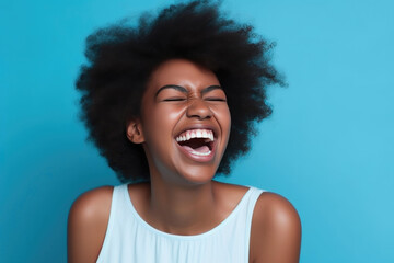 Energetic young African-American woman enjoying a laugh against a vibrant blue backdrop. Generative AI