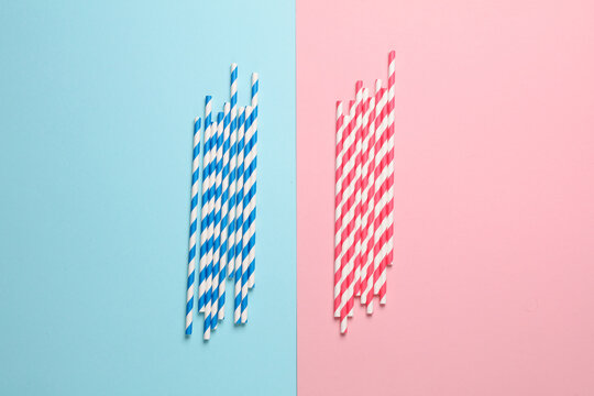 Blue and red paper straws on pastel background. Party, birthday accessories