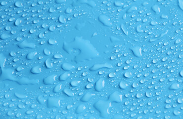 Blue background in water drops close up