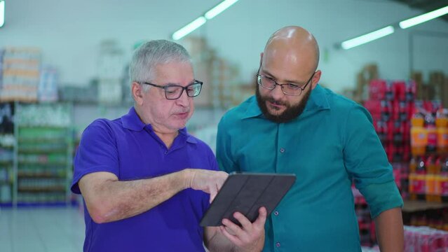 Local Grocery Store Senior Manager Delegating Tasks via Tablet Device