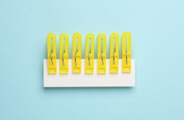 Set of plastic clothespins on a blue background