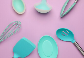 Silicone kitchen utensils on a pastel background. Top view