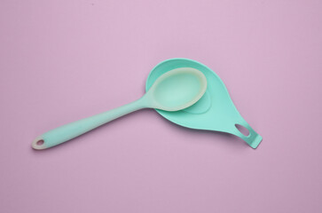 Silicone kitchen utensils on a pastel background. Top view