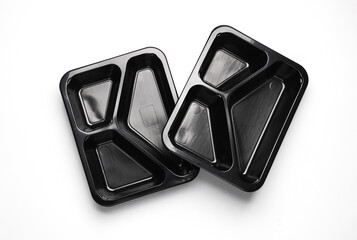 Disposable black plastic empty food containers on gray background. Top view