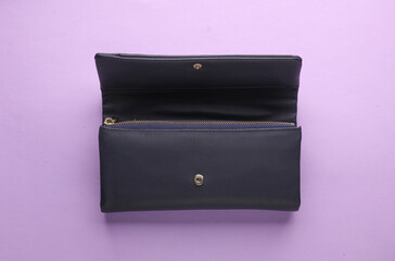 Open leather fashion wallet on a lavender background