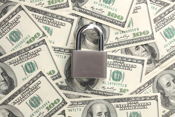 Protect your finances. Metal lock on hundred dollar bills