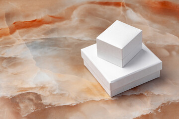 White jewelry box on a white marble background