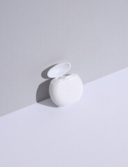 Dental floss on a white gray background. Beauty concept. Creative layout, minimalism