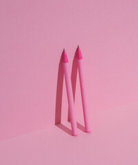 Plastic pink pens on pink background. Business, education concept. Creative layout, minimalism. Modern art