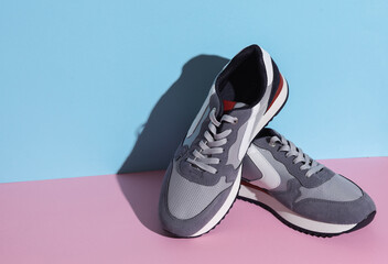 Sports sneakers on a blue pink background. Creative layout, minimalism