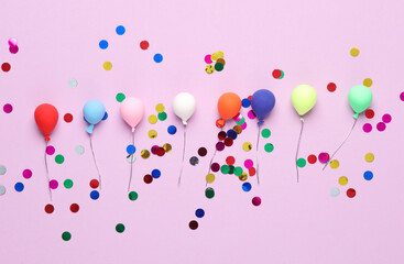 Miniature balloons with confetti on a pink background. Birthday concept