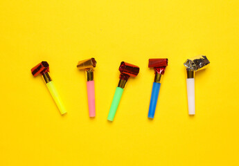 Birthday horns on yellow background. Party concept