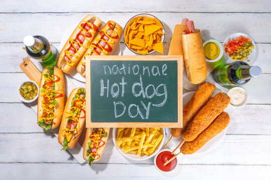 National Hot Dogs day background, hotdog summer party festival foods, Various type of traditional hot dogs - french, corn dog, classic. mexican loaded hotdog, with snack, beer bottles and sauces