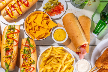 National Hot Dogs day background, hotdog summer party festival foods, Various type of traditional hot dogs - french, corn dog, classic. mexican loaded hotdog, with snack, beer bottles and sauces
