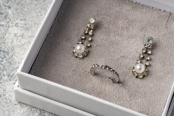 Jewelry box with earrings on a gray background