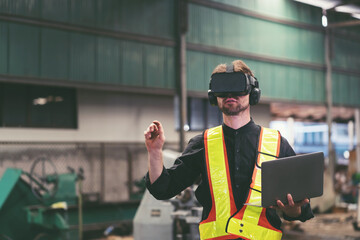 Male factory mechanic using virtual reality headset. Male engineer working or using virtual reality headset for checking machinery in industry factory and wearing safety uniform and helmet