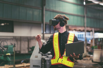 Fototapeta na wymiar Male factory mechanic using virtual reality headset. Male engineer working or using virtual reality headset for checking machinery in industry factory and wearing safety uniform and helmet