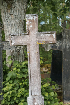 Old empty stone cross in ancient cemetery.