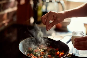 Acrylglasbilder Restaurant Young woman cooking in the kitchen  © Geber86