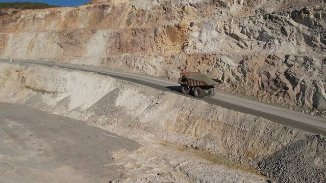 aerial view shot open pit mine coal mining, dumpers, quarrying extractive industry stripping work