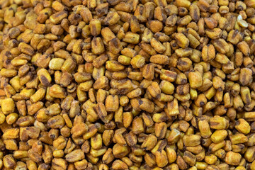 Roasted salted corn snack. Toasted corn nuts. Pattern of yellow corn seed. Top view.