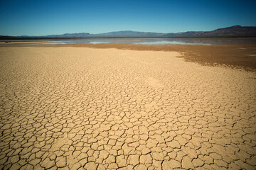 Rain water flooding the dried up lake mud bed