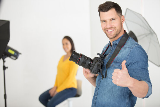 photographer thumb up with woman model posing for a photo