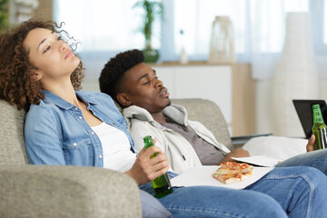 Obraz na płótnie Canvas sleeping couple sits on a sofa