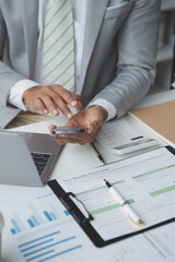 Financial analysts analyze business financial reports on a digital tablet planning investment...