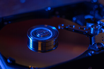 Computer hard drive without protective cover. Close up of hard disk with abstract reflection. Opened hard drive from the computer hdd with mirror effects Part of computer pc. Soft selective focus