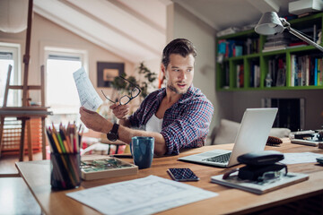 Young man working from home on his laptop