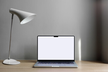 laptop on the table with space for a signature. Macbook 14 pro 2021. gray wall, hotel workplace.copy space